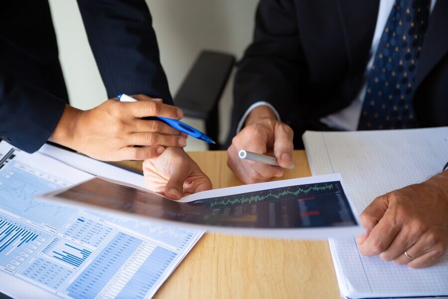 investor-broker-discussing-trading-strategy-holding-papers-with-financial-charts-pens-cropped-shot-broker-job-investment-concept_74855-14251 (1)
