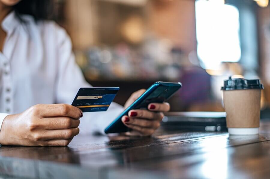pay-goods-by-credit-card-through-smartphone-coffee-shop_1150-18770